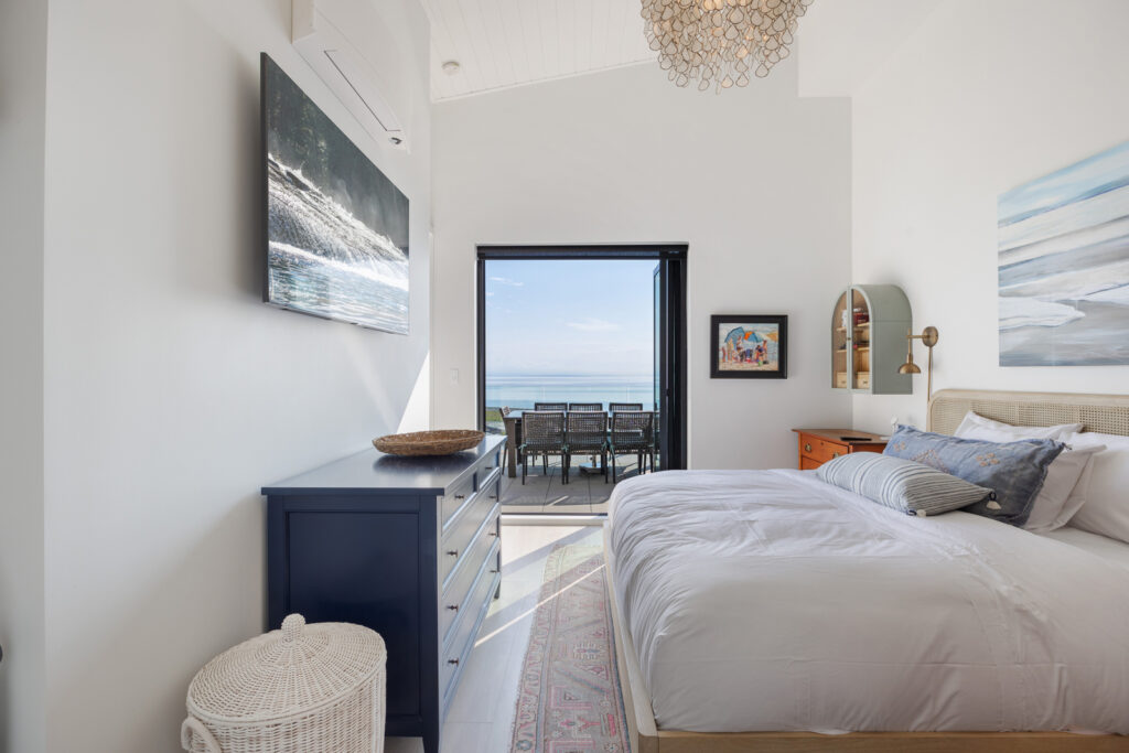 Beachfront Primary Bedroom with ocean view and direct patio access
